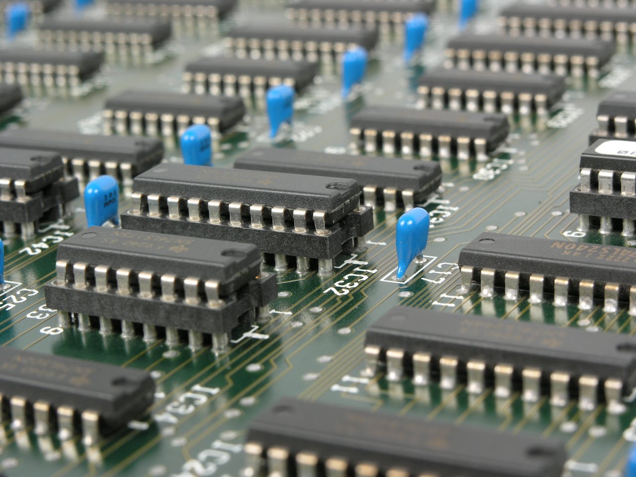 gallery-02 Detailed macro shot showcasing integrated circuits and components on electronic motherboard.