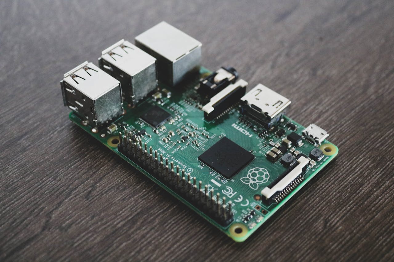 gallery-03 Detailed view of a Raspberry Pi circuit board with microchips and components.