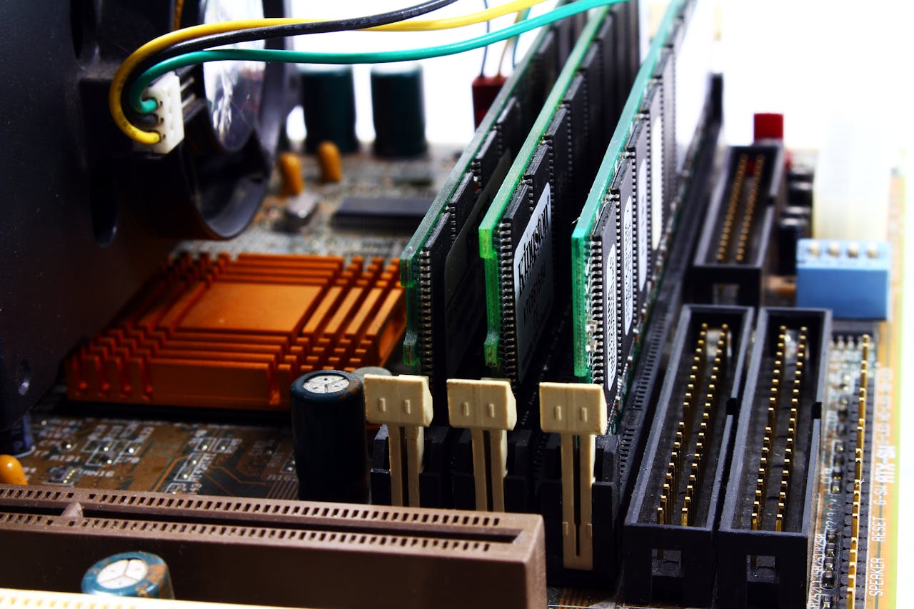 our-story Detailed view of computer motherboard featuring RAM, chipset, and wiring.