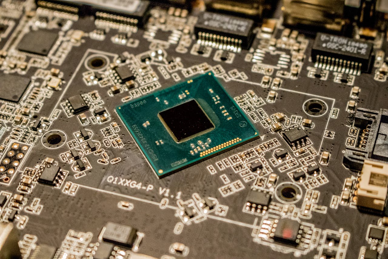 gallery-04 Detailed view of a microchip on a printed circuit board, showcasing electronic components.